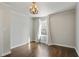 Bedroom with hardwood floors, modern chandelier and white trim and paint at 1989 Mount Vernon Rd, Atlanta, GA 30338