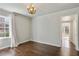 Bedroom with hardwood floors, modern chandelier and neutral paint at 1989 Mount Vernon Rd, Atlanta, GA 30338