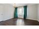 Charming dining room featuring gleaming hardwood floors and large window with curtains at 1989 Mount Vernon Rd, Atlanta, GA 30338