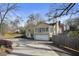 Rear exterior of home with attached garage and sunroom boasting ample natural light at 1989 Mount Vernon Rd, Atlanta, GA 30338