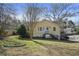 Charming yellow home featuring a well-manicured front lawn and inviting curb appeal at 1989 Mount Vernon Rd, Atlanta, GA 30338