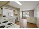 Cozy eat-in kitchen with white cabinetry, stainless steel dishwasher and hardwood floors at 1989 Mount Vernon Rd, Atlanta, GA 30338