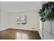 Bright living room featuring hardwood floors, a large window and fresh, white paint at 1989 Mount Vernon Rd, Atlanta, GA 30338