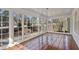 Light-filled sunroom featuring hardwood floors and large windows showcasing the outdoors at 1989 Mount Vernon Rd, Atlanta, GA 30338