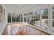 Light-filled sunroom featuring hardwood floors and large windows showcasing the outdoors at 1989 Mount Vernon Rd, Atlanta, GA 30338