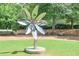 Stunning outdoor art piece stands prominently on a manicured lawn with trees and seating at 2045 Old Forge Way, Marietta, GA 30068