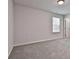 Well-lit bedroom with neutral carpeting and bright natural lighting at 220 Eastmark Way, Fayetteville, GA 30214