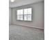 Bright bedroom featuring neutral carpeting and a large window for natural light at 220 Eastmark Way, Fayetteville, GA 30214