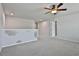 A versatile bonus room with carpet, ceiling fan, and a half wall great for an office or ' area at 220 Eastmark Way, Fayetteville, GA 30214