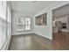 Bright dining area with hardwood floors and natural light flowing from the large windows and a view to the kitchen at 220 Eastmark Way, Fayetteville, GA 30214