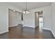 Dining room with views to other rooms, wood floors, and modern lighting at 220 Eastmark Way, Fayetteville, GA 30214