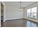Dining room with hardwood floors, modern light fixture, and large window at 220 Eastmark Way, Fayetteville, GA 30214