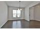 Bright dining room features a modern chandelier and a large window overlooking the front yard at 220 Eastmark Way, Fayetteville, GA 30214