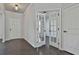 Entryway boasts stylish french doors leading to a flex room, wood floors, and neutral paint at 220 Eastmark Way, Fayetteville, GA 30214
