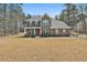 Charming two-story brick home with a covered porch and professionally landscaped front yard at 220 Eastmark Way, Fayetteville, GA 30214