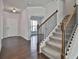 Welcoming foyer with hardwood floors, a staircase with rod iron and a view to the living area at 220 Eastmark Way, Fayetteville, GA 30214