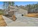 View of attached two-car garage with concrete driveway at 220 Eastmark Way, Fayetteville, GA 30214