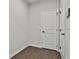 A clean hallway with hardwood floors, neutral walls, and white doors, providing a seamless transition between rooms at 220 Eastmark Way, Fayetteville, GA 30214