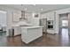 Bright kitchen features stainless appliances, a kitchen island, and hardwood floors at 220 Eastmark Way, Fayetteville, GA 30214