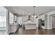 Bright kitchen features white cabinets, stainless appliances, a kitchen island, and hardwood floors at 220 Eastmark Way, Fayetteville, GA 30214