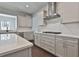 Kitchen featuring white cabinets, quartz countertops, stainless appliances, and hardwood floors at 220 Eastmark Way, Fayetteville, GA 30214