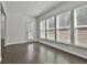 Inviting living area featuring sleek hardwood floors, large windows, and easy access to the outdoors at 220 Eastmark Way, Fayetteville, GA 30214