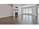 Spacious living room features wood floors, fireplace, fan, and lots of natural light at 220 Eastmark Way, Fayetteville, GA 30214