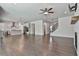 Spacious living space offers fireplace, staircase, view of kitchen, and wood floors at 220 Eastmark Way, Fayetteville, GA 30214