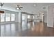 Open-concept living space boasts wood floors, modern lighting and easy access to kitchen at 220 Eastmark Way, Fayetteville, GA 30214