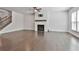 Open concept living space with fireplace, staircase, and hard wood floors at 220 Eastmark Way, Fayetteville, GA 30214