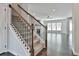 Carpeted stairs with wood and iron railing lead to upper level at 220 Eastmark Way, Fayetteville, GA 30214