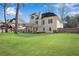 A large backyard features a deck, patio, fire pit, and lush green lawn, ideal for outdoor enjoyment at 3015 Foxhall Overlook, Roswell, GA 30075
