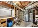 Unfinished basement space featuring exposed ductwork, workbench, and utility connections at 3015 Foxhall Overlook, Roswell, GA 30075