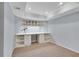Finished basement area, carpeted, with built in shelving unit with desk, ideal for a home office at 3015 Foxhall Overlook, Roswell, GA 30075