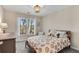 Cozy bedroom with a lion-themed bedspread and a large window with wooded views at 3015 Foxhall Overlook, Roswell, GA 30075