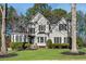 Charming two-story home with well-manicured lawn and mature trees creating a picturesque curb appeal at 3015 Foxhall Overlook, Roswell, GA 30075