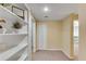 Hallway with neutral carpet, a closet and a built-in shelving unit on the left wall at 3015 Foxhall Overlook, Roswell, GA 30075