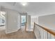Upstairs hallway with tan carpet leading to bedrooms and view of living room below at 3015 Foxhall Overlook, Roswell, GA 30075
