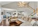 Bright living room with vaulted ceilings, a cozy sectional sofa, and open access to the kitchen at 3015 Foxhall Overlook, Roswell, GA 30075