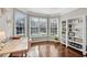 Sunlit home office with built-in bookshelves, hardwood floors, and a cozy workspace at 3015 Foxhall Overlook, Roswell, GA 30075