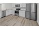 Modern kitchen with stainless steel appliances, granite countertops, and ample cabinet space at 3575 Bonneville Dr, Cumming, GA 30041