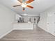Open-concept living room showcases wood floors, kitchen view, and ceiling fan at 3575 Bonneville Dr, Cumming, GA 30041
