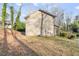 Side yard of the home with a sloped, grassy landscape at 3575 Bonneville Dr, Cumming, GA 30041