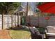 Landscaped backyard with wooden fence, patio set, and whimsical decor at 974 Grant Se St, Atlanta, GA 30315