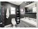 Modern bathroom with sleek gray vanity, unique floors, and tiled walk-in shower at 974 Grant Se St, Atlanta, GA 30315