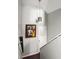 Hallway with high ceilings, modern hanging light fixture, gray walls, and unique art at 974 Grant Se St, Atlanta, GA 30315