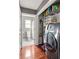 Laundry room with shelves, washer, and dryer, with view to updated bathroom at 974 Grant Se St, Atlanta, GA 30315