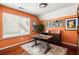 Office space with large window, modern desk and storage, and warm paint color at 974 Grant Se St, Atlanta, GA 30315