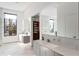 Bright bathroom features double vanity, large window with natural light, and an adjacent walk-in closet at 1051 Wimberly Ne Rd, Brookhaven, GA 30319