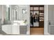 Bathroom vanity with storage and sinks adjacent to a walk in closet with custom shelving at 1051 Wimberly Ne Rd, Brookhaven, GA 30319